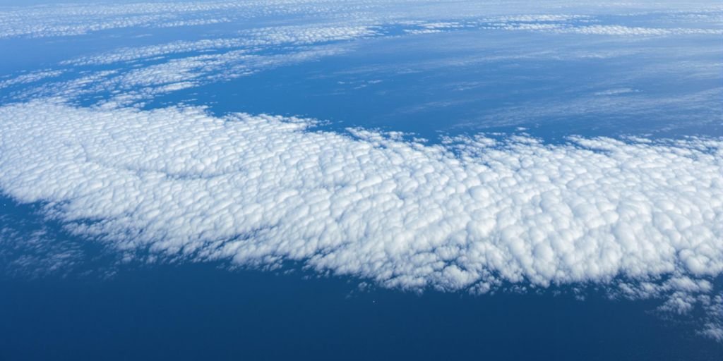 Nuage de vapeur d'eau s'étendant sur une vaste étendue d'eau.
